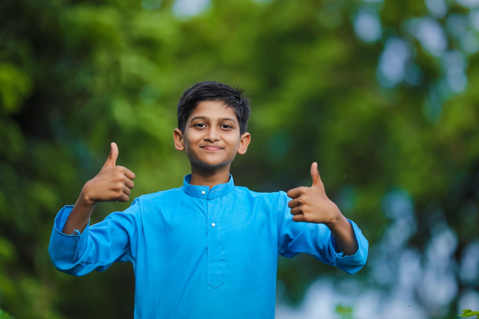 cute indian little child in traditional wear and standing at agriculture field