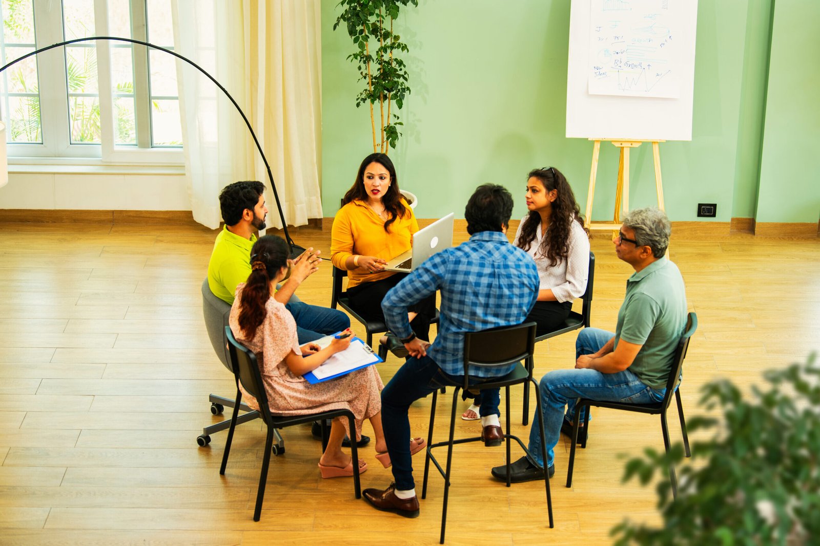 indian business team discussing mental health and teamwork in professional corporate office setting