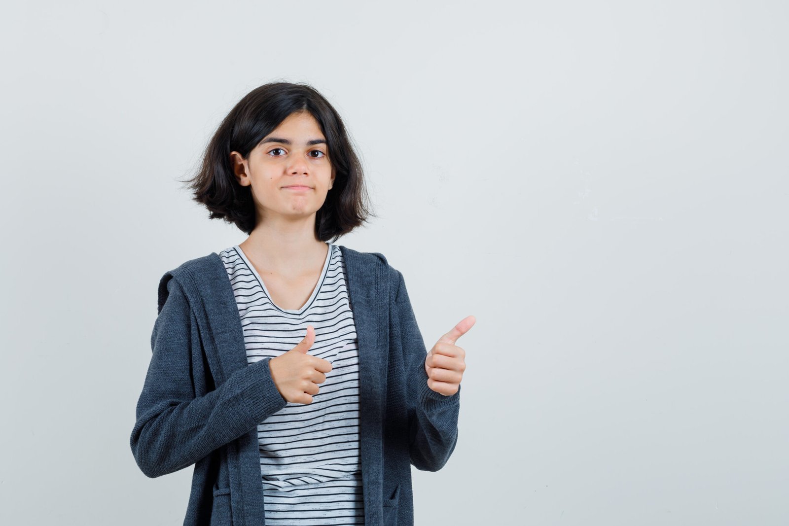 little girl in t shirt, jacket showing double thumbs up and looking confident , front view.
