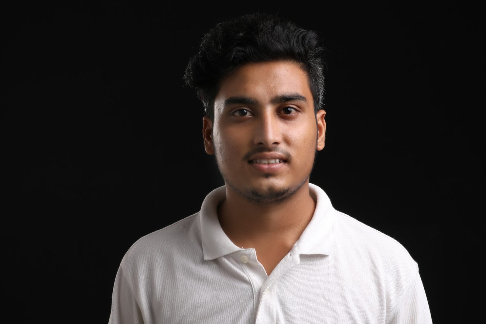 young indian man showing expression on dark background